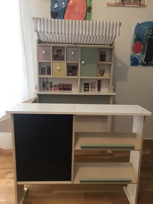 Wooden play shop with accessories and blackboard