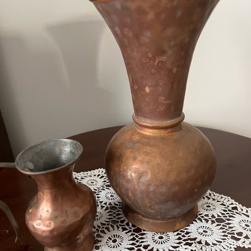 Two decorative hammered copper vases used with natural patina