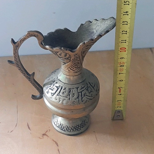 Oriental solid brass pitcher used with saucer