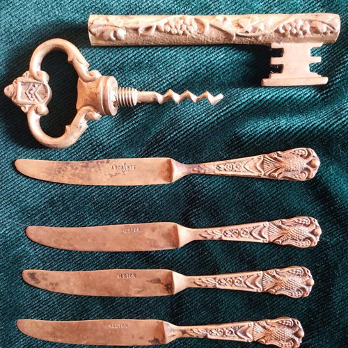 Set of used bronze knives and opener