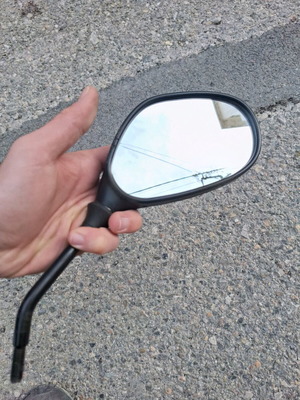 Right mirror used for low displacement motorcycle, possibly Honda