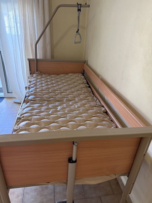 Electric hospital-style care bed with mattress