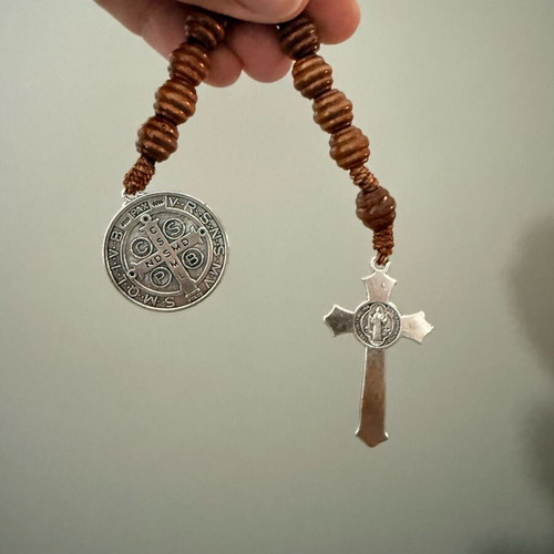 Religious bracelet with wooden beads, cross pendant, and Saint Benedict medal