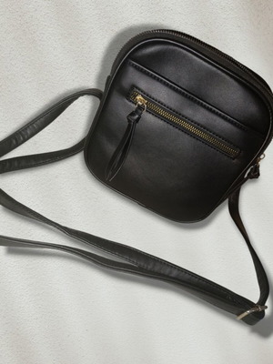 Black crossbody bag used with double zipper and adjustable strap