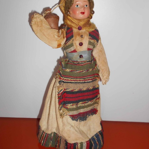 Folk handmade doll used with traditional costume and water jug