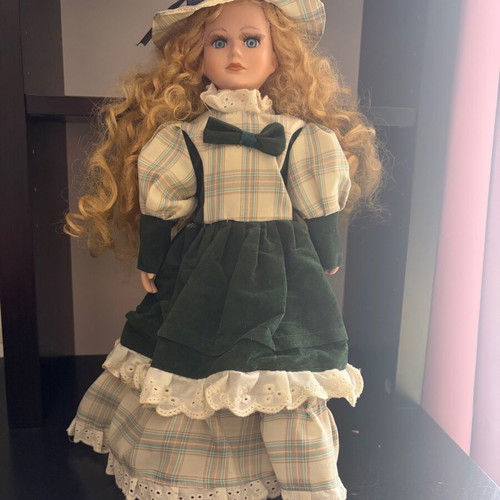 Porcelain doll like new with curly blonde hair and hat