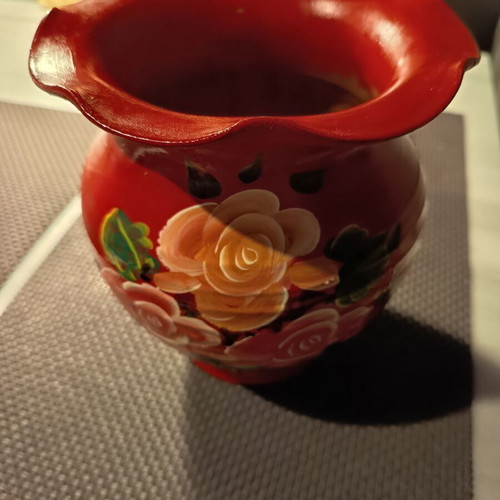 Handmade traditional clay vase with painted flowers