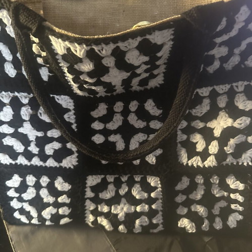Handmade jute bag with black and white crochet motifs