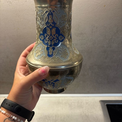 Vintage metal vase used with embossed designs and blue details