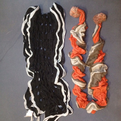 Set of 2 knitted Sprider scarves like new, black and white and orange with pom-poms