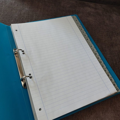 Binder with index used, includes plastic sleeves and lined A4 sheets