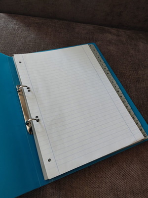 Binder with index used, includes plastic sleeves and lined A4 sheets