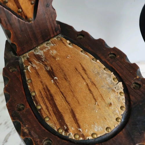Spanish rustic chair used with three legs and animal leather from the 1960s