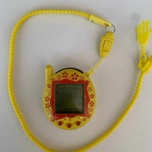 Tamagotchi 2006 yellow red flower used handheld virtual pet