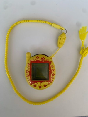 Tamagotchi 2006 yellow red flower used handheld virtual pet
