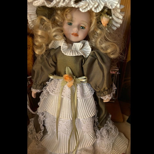Porcelain doll new with vintage clothes collectible