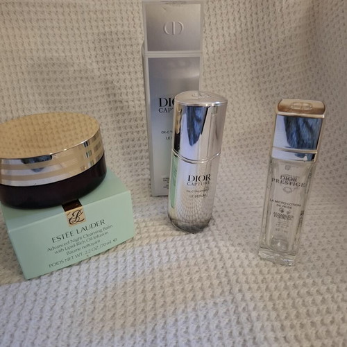 Empty Dior and Estèe Lauder cosmetic jars used, set
