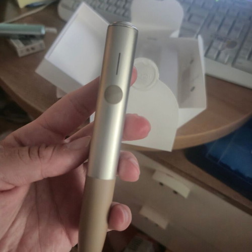 Iqos ILUMA One Gold device used with box and cable