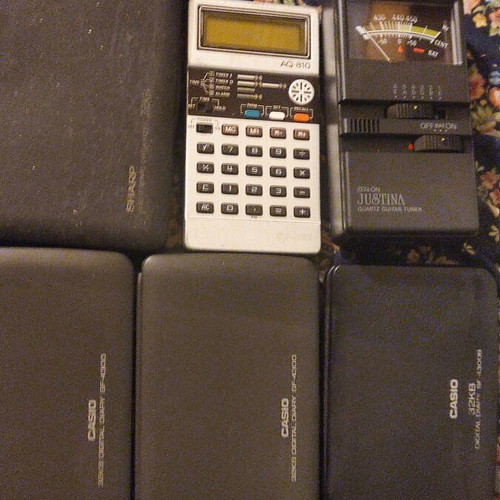 Collection of 6 handheld calculators including Casio, Sharp, and guitar tuner