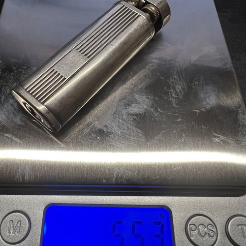 Silver lighter used, unknown if working