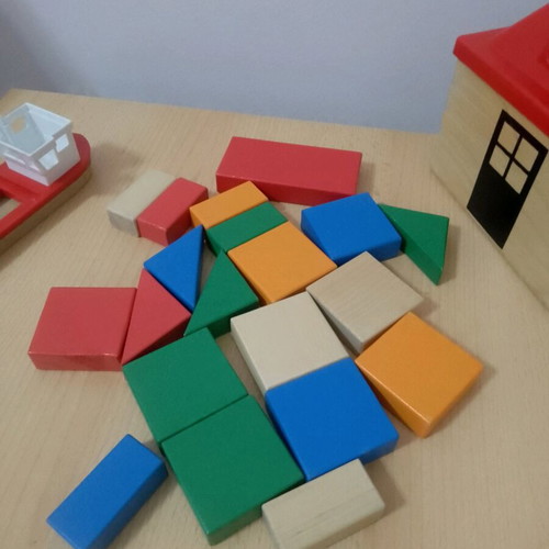 Wooden toys used with house, boat, and shapes