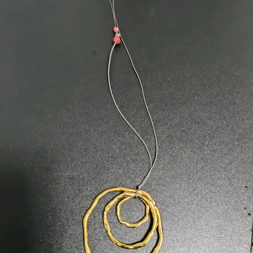 Long necklace like new, gold color with brown cord