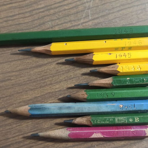 Wooden stationery box with used pencils and ink cartridges set