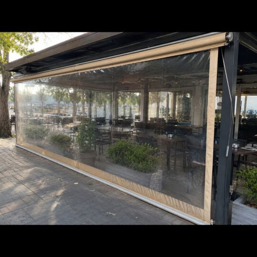 Vertical transparent PVC awnings used with mechanism for cafes and restaurants