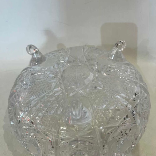 Vintage crystal bowl with feet and embossed carved designs, used