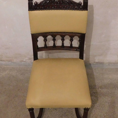 Wood-carved chair with leather seat like new, about 100 years old