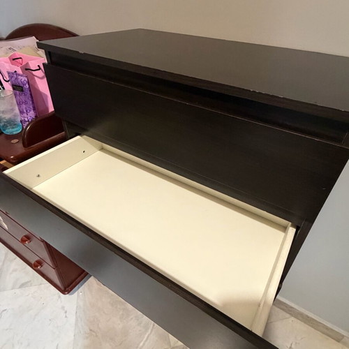 Dark brown wooden chest of drawers used with minimal wear