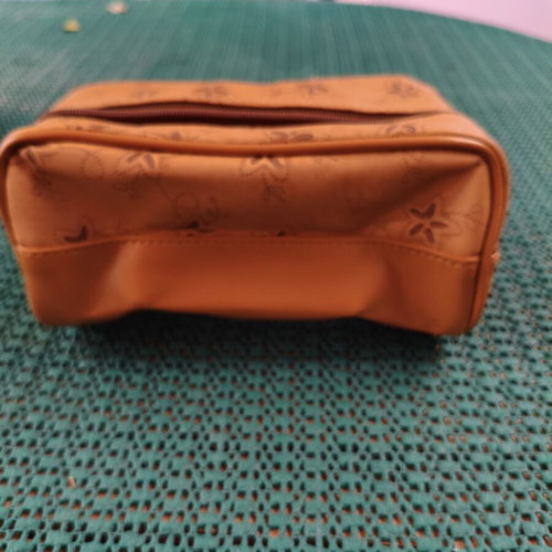 Women's cosmetic bag with floral punch-out design, synthetic leather, camel