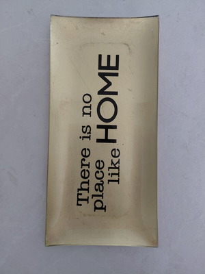 Decorative gold platter used with "There is no place like HOME" inscription