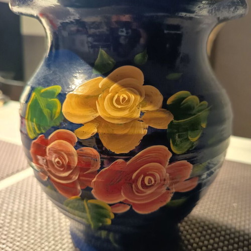 Handmade traditional clay vase with painted flowers