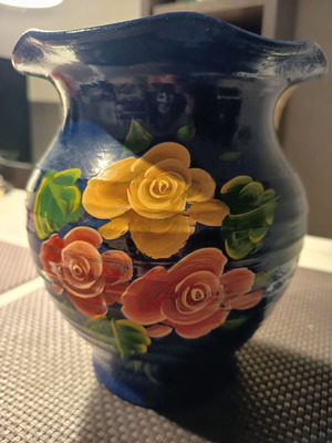 Handmade traditional clay vase with painted flowers