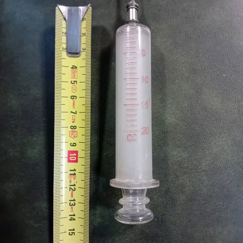 Antique glass syringe used with needle box