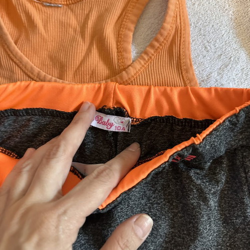 Girls' sports set with grey leggings and orange tank top, size 10