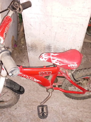 Children's bicycle used with flat tires and minor damages red