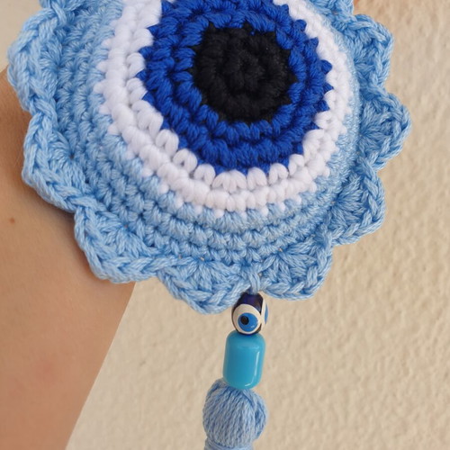 Handmade baby blue crocheted eye decoration