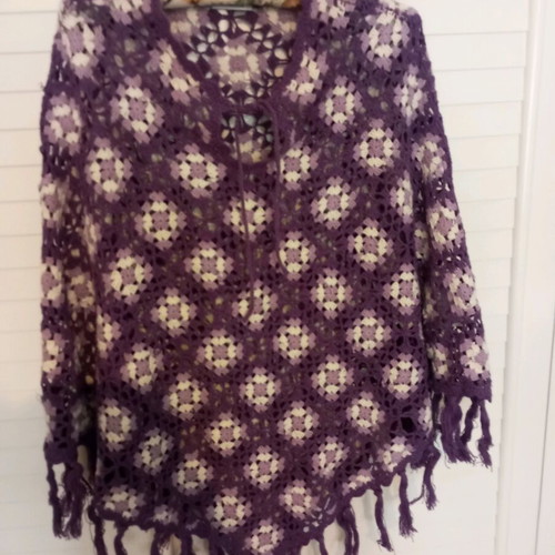 Handmade knitted poncho used in purple shades with fringes