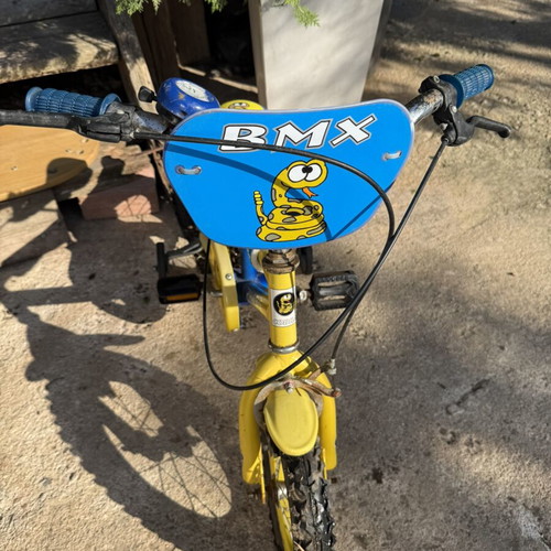 Kids BMX bike used, blue and yellow with snake design