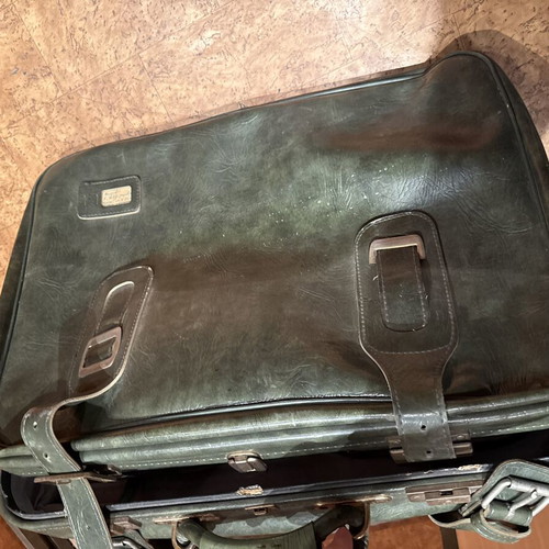 Vintage leather suitcase in dark green