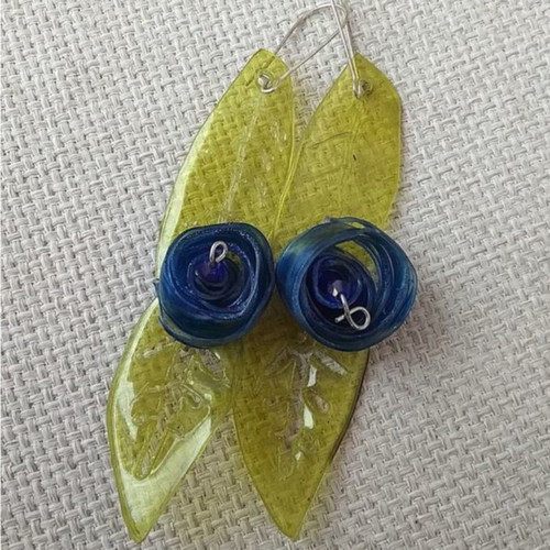 Earrings handmade from scratch with blue and green recycled plastic flowers and leaves