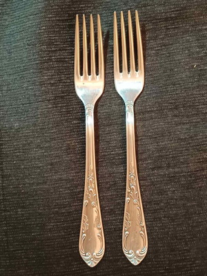 Set of two vintage silver-plated forks used with art deco embossed decoration