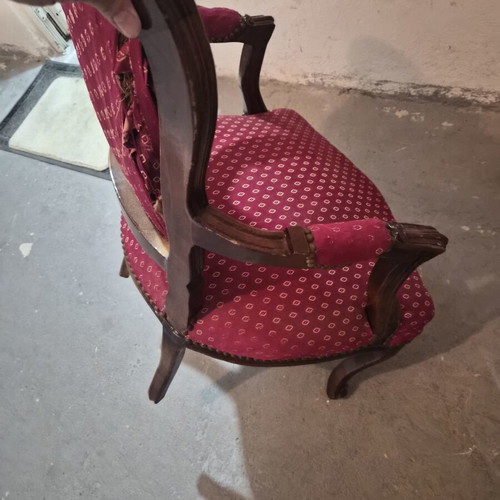 Armchair with carved wood frame and red fabric