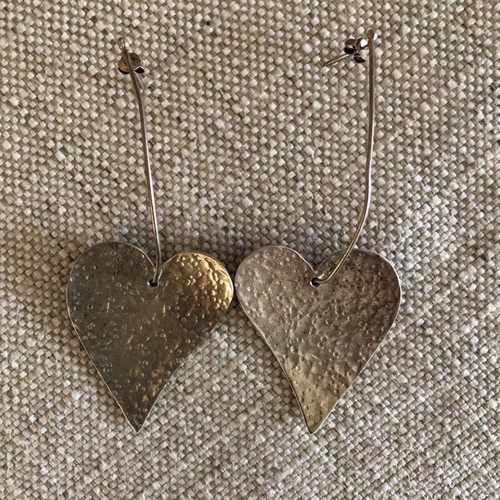 Silver earrings used in heart shape