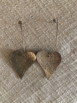 Silver earrings used in heart shape