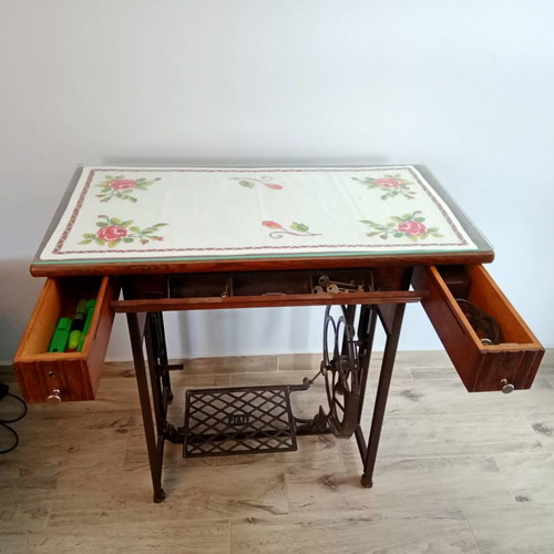 Antique sewing machine used with furniture and accessories