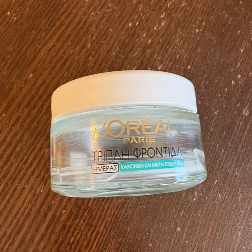 L’Oréal day cream bottle used, empty