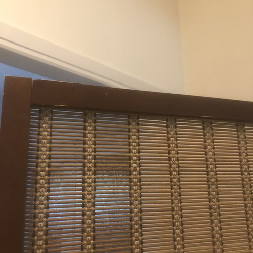 Brown bamboo room divider with slight wear